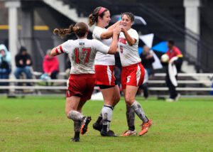 soccer players cheering and hugging