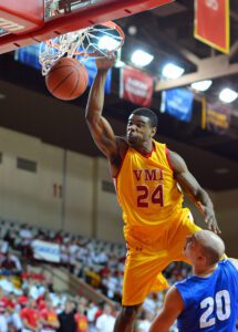 D.J. Covington ’14 grabs the rim after making a shot in Cameron Hall during a game