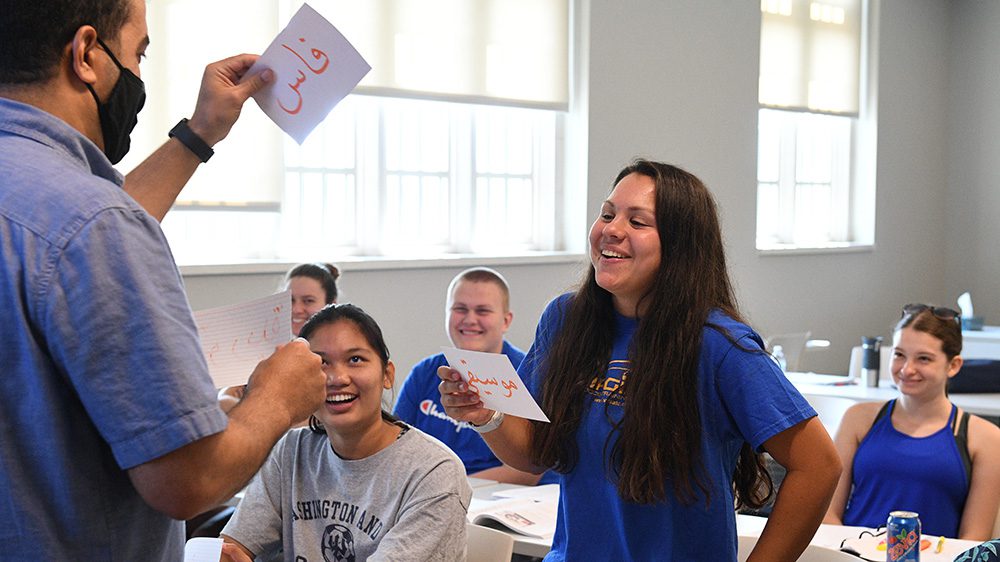 Maj. Hicham Assaoui shares a light moment with students from Arabic language program.