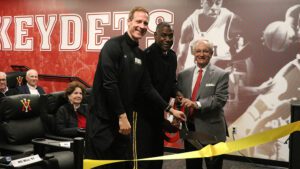 Andrew Wilson, Maj. Gen. Cedric Wins '85, and John Kemper '68 cut ribbon at film room dedication.