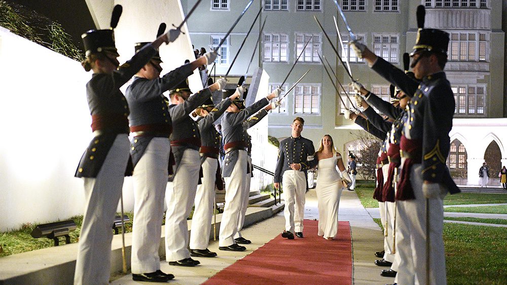 Cadets and their dates pass through a saber cordon before entering the Ring Figure ball in Cocke Hall.