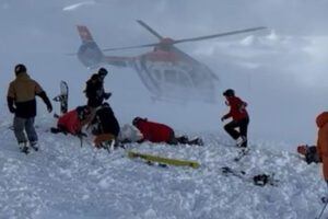 Skiers helping avalanche victims