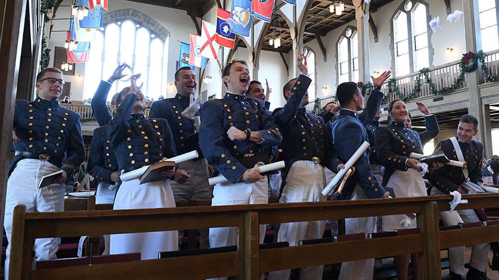 Cadets throwing gloves in the air