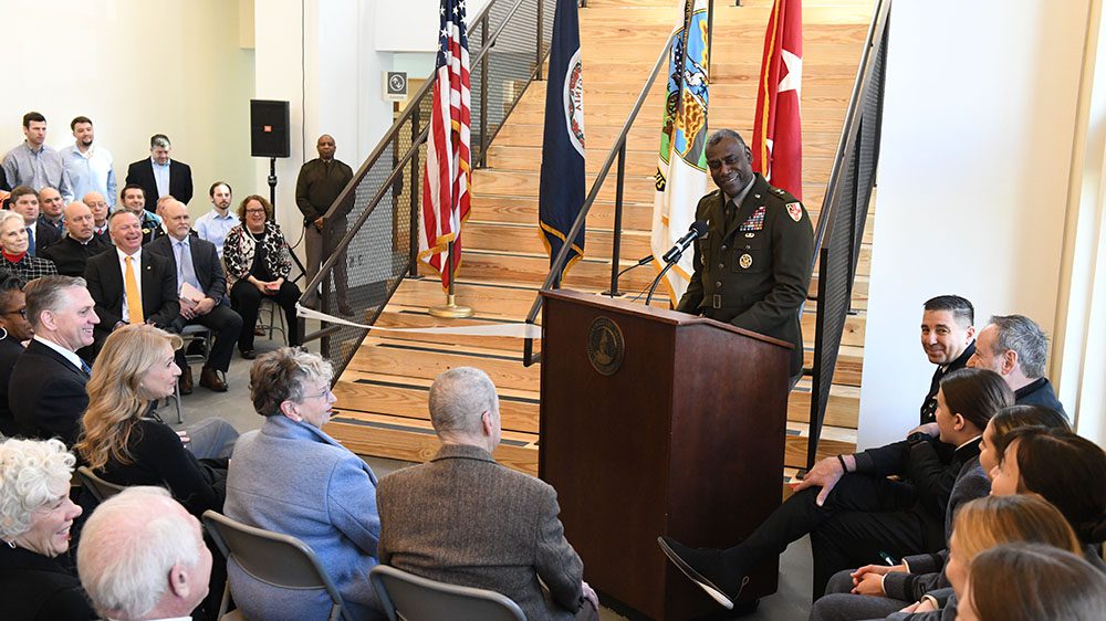 Maj. Gen. Cedric Wins '85 addressing audience from podium at Aquatic Center dedication.