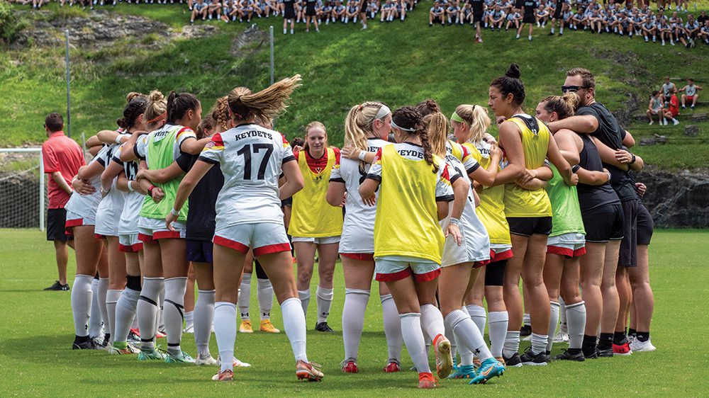 soccer players in huddle