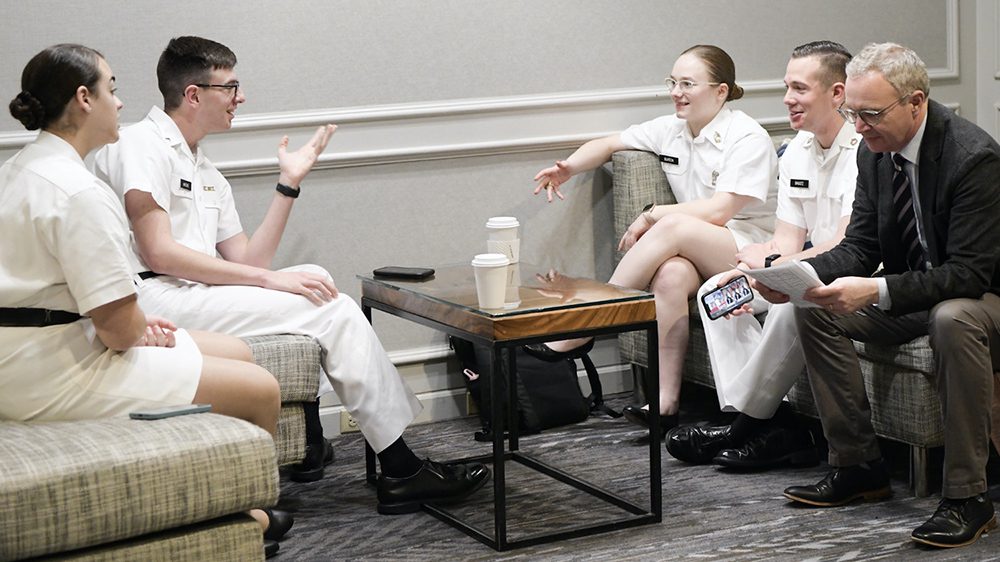 Ethics team sitting around a coffee table talking