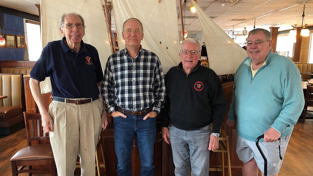 small group of older alumni smiling