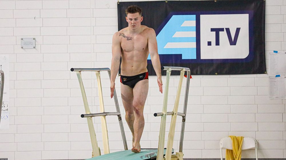 diver preparing to jump off diving board