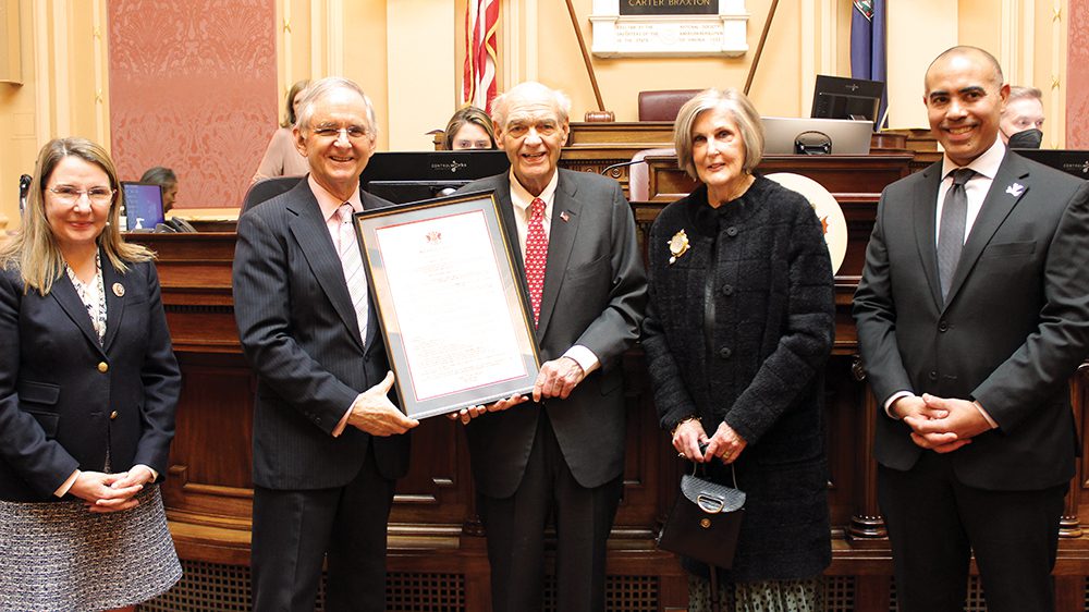 G. Gilmer “Gil” Minor III ’63 receives the 2023 Outstanding Virginian Award in the Virginia House of Delegates House chamber session Feb. 13, 2023. Pictured are (from left) Sen. Siobhan S. Dunnavant; Sen. Thomas Norment Jr. ’68; Minor; Charlotte Minor, Minor’s wife; and Ian H. Solomon, Frank Batten School of Leadership and Public Policy dean.