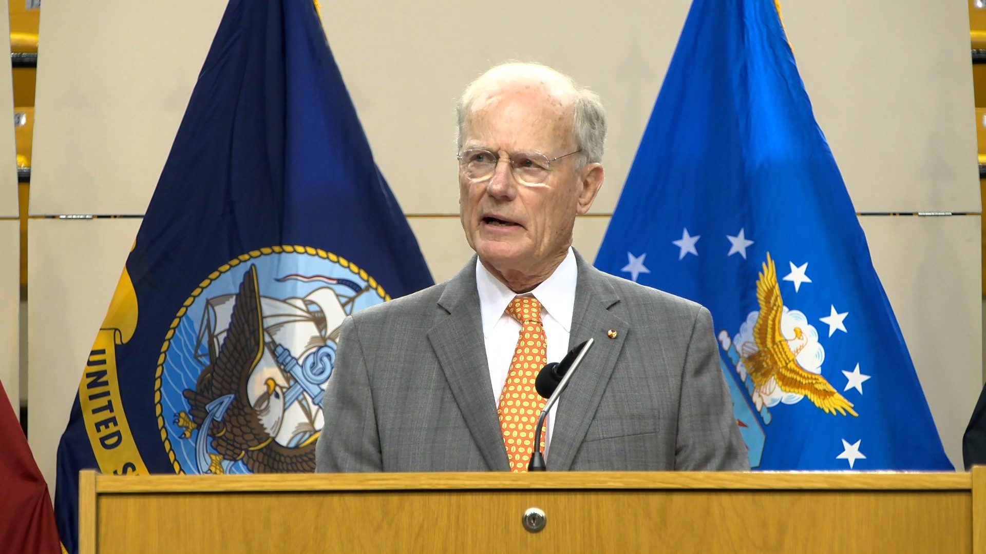 Conrad Hall '65 speaking at a podium.