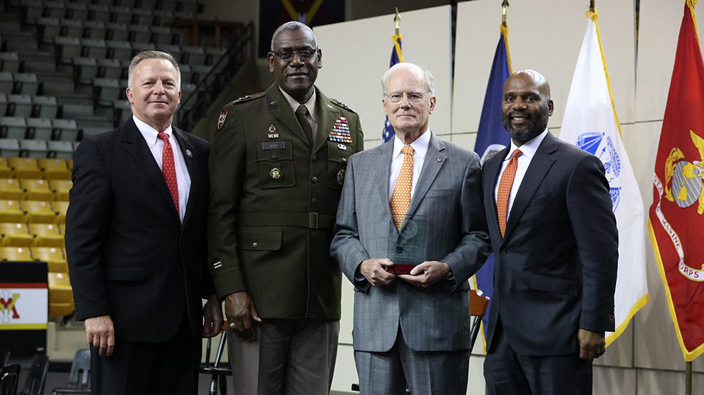 Conrad M. Hall '65 holding Distinguished Service Award, standing with David Prasnicki, Maj. Gen. Cedric T. Wins, and Ernesto P. Sampson.