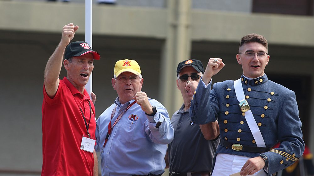 alumni and 1st Class cadet do an Old Yell on top of the sentinel box in VMI barracks