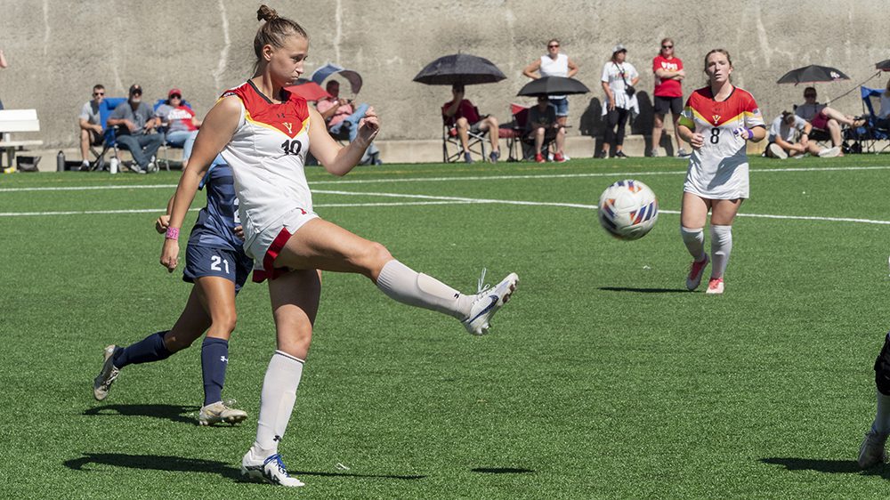VMI women’s soccer players Audrey Davis ’25 kicking a soccer ball