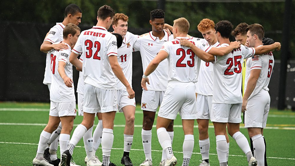 men's soccer players in huddle