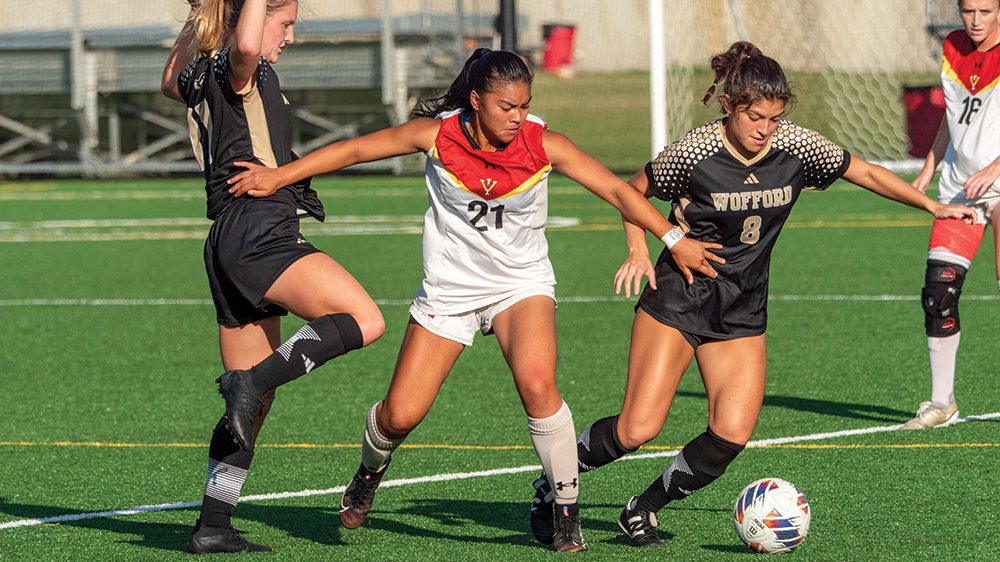 women's soccer players in action on field