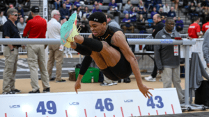 Keyandre Midgett ’24 clearing a hurdle during a track meet