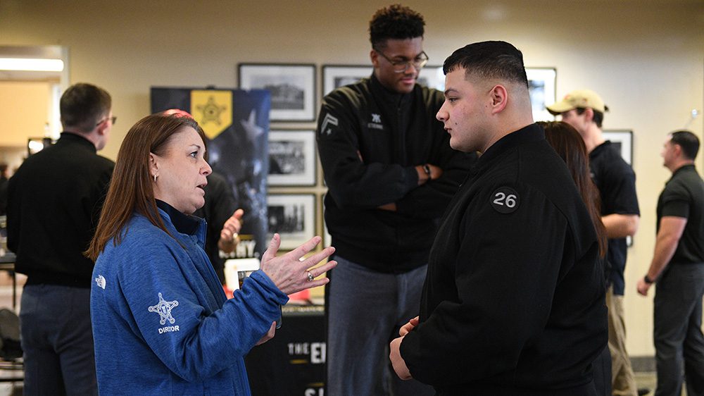 woman talks to VMI cadet