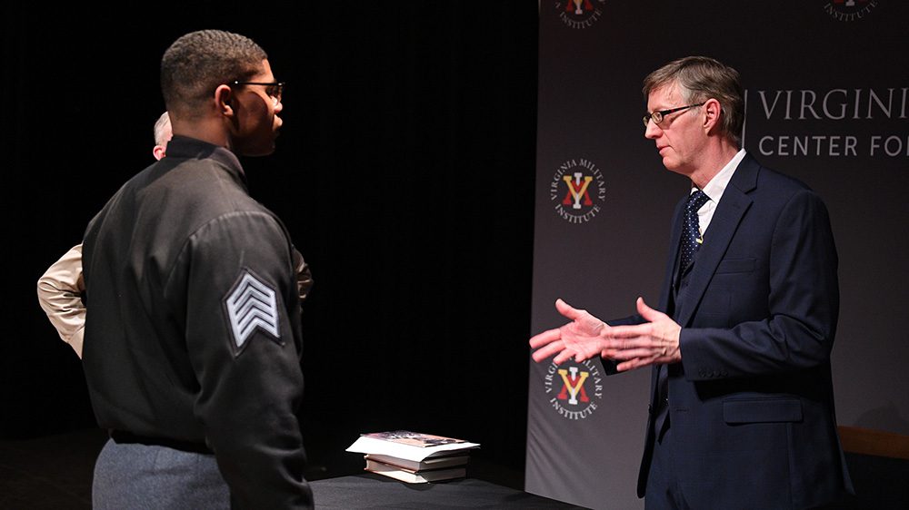 Robert Child talks with a cadet after his presentation in Gillis Theater.