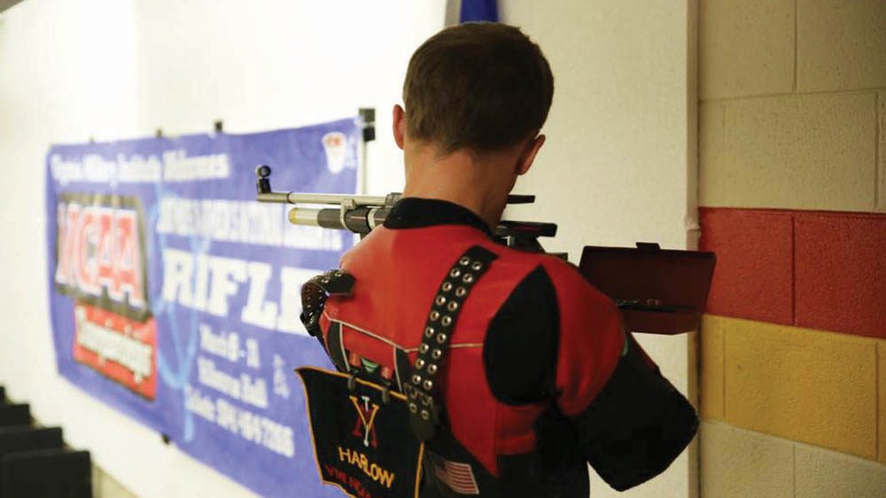 rifle team member aiming rifle