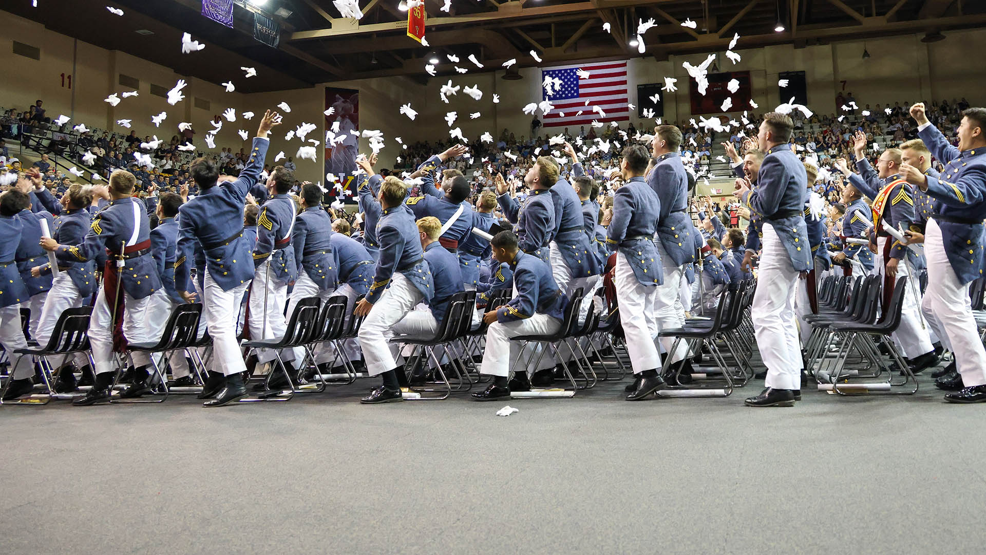cadets throwing gloves in the air