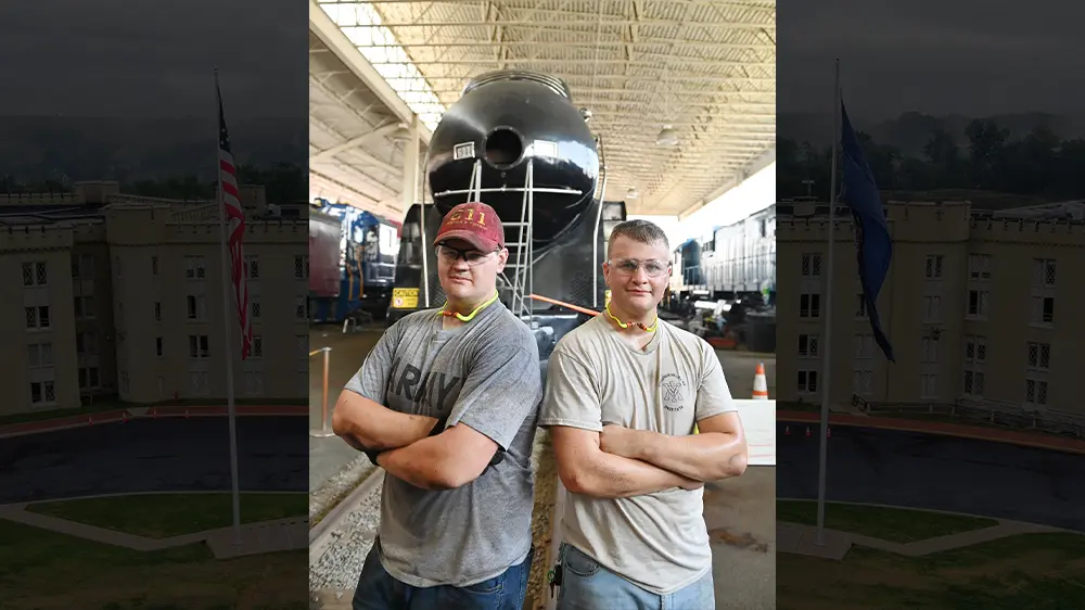 Andrew Quesenberry ’26 and his younger brother, Ryan in front of 611 steam engine
