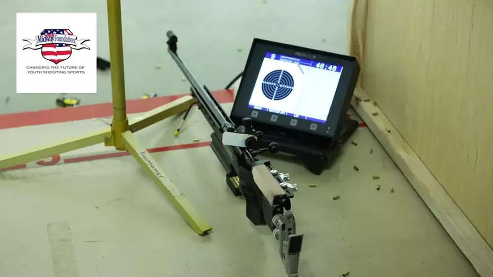 rifle on ground with Midway Foundation logo in corner