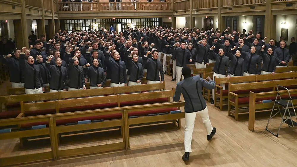class giving an old yell in Memorial Hall