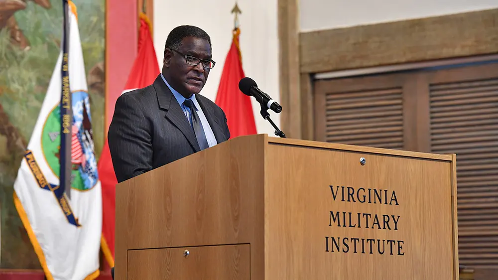 Gene Williams '74 speaking at a lecturn