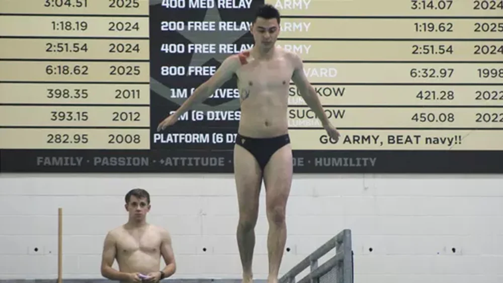 male diver getting ready to dive into pool