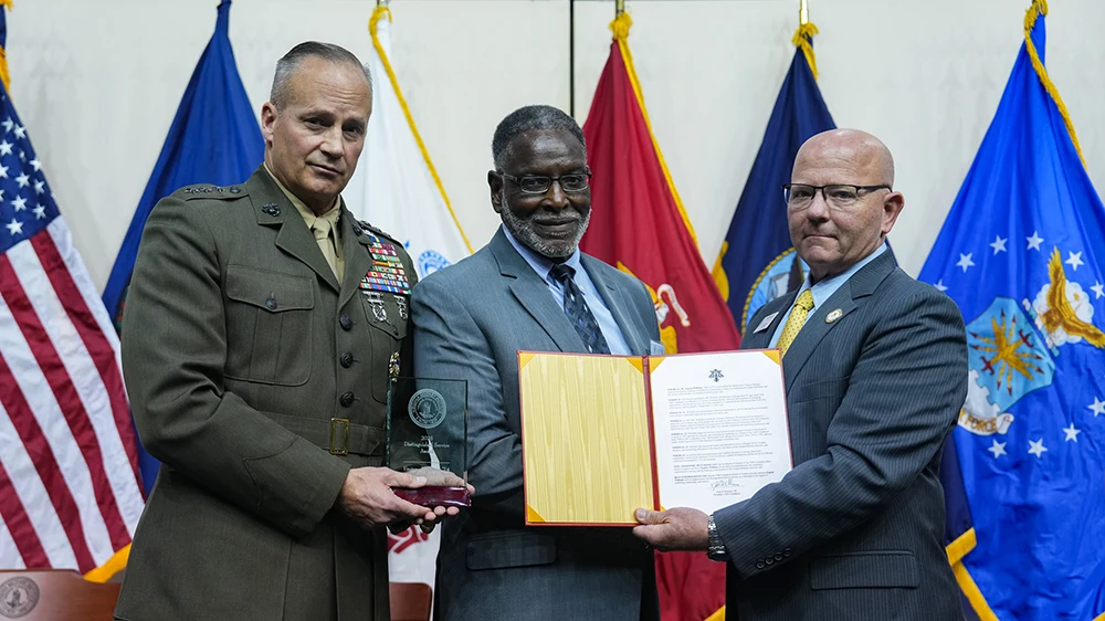 Lt. Gen. David Furness '87, superintendent (left) and John Williams '88, VMI Foundation president (right) present the VMI Foundation's Distinguished Service Award to Eugene 