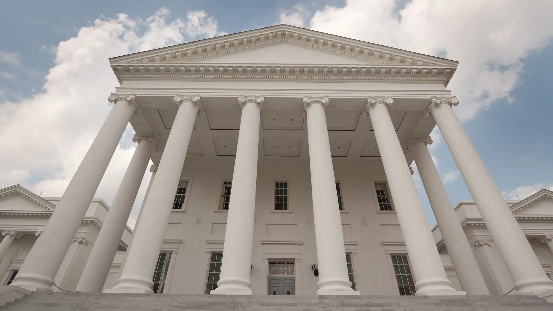 A low shot looking up at the Virginia State Capitol building