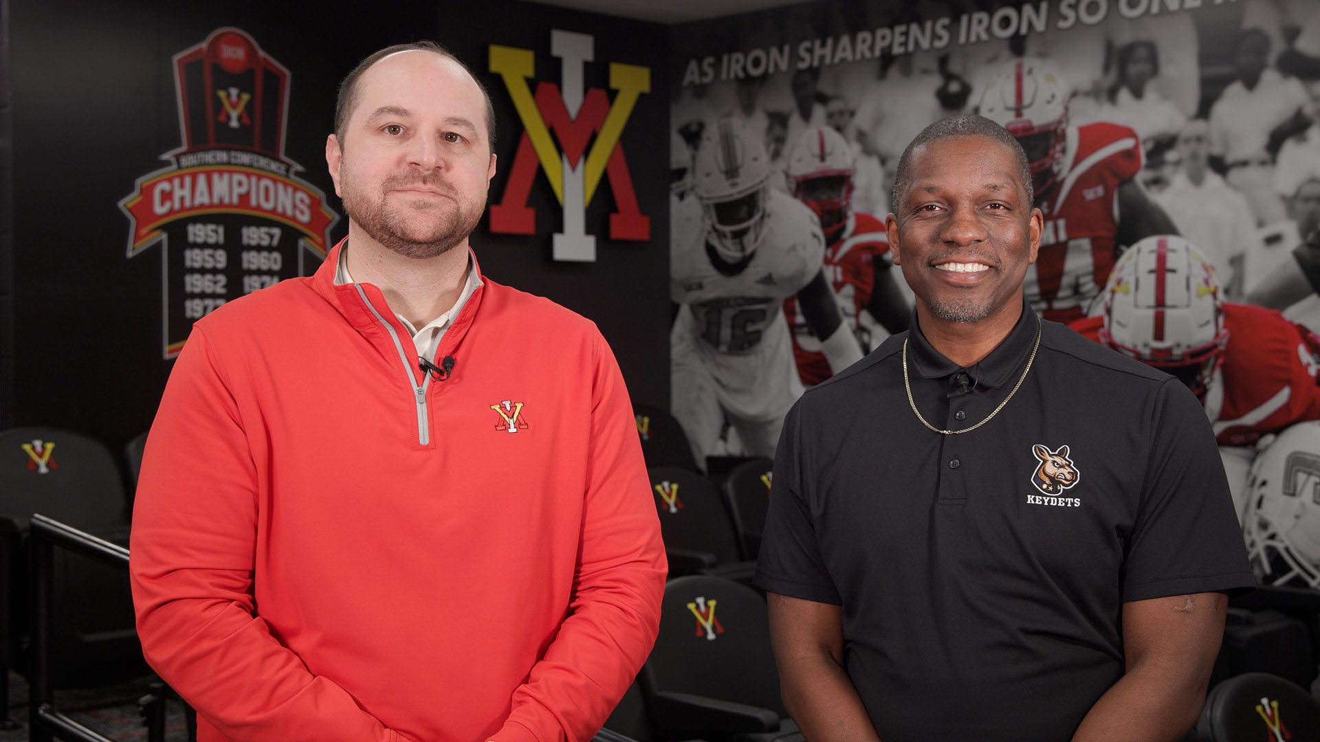 Andrew Deal and Jamaal Walton standing in an athletics facility smiling