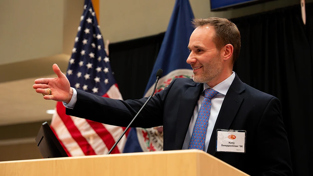 Kelly Sweppenhiser '06 speaking at podium