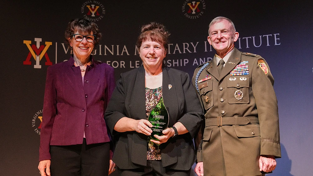 Becky Gwynn accepts the Erchul Environmental Leadership Award from Tanya Denckla Cobb and Col. Dave Gray, Ph.D., in Gillis Theater.