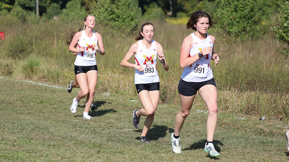 female cross country athletes running